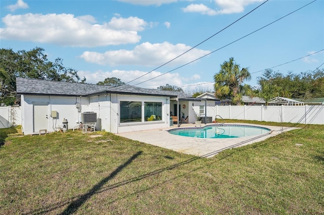 back of house with a patio, a fenced in pool, a lawn, and central air condition unit