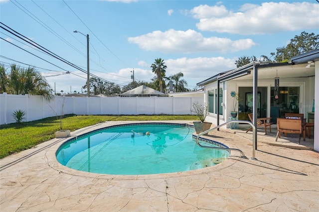 view of swimming pool with a patio area and a lawn