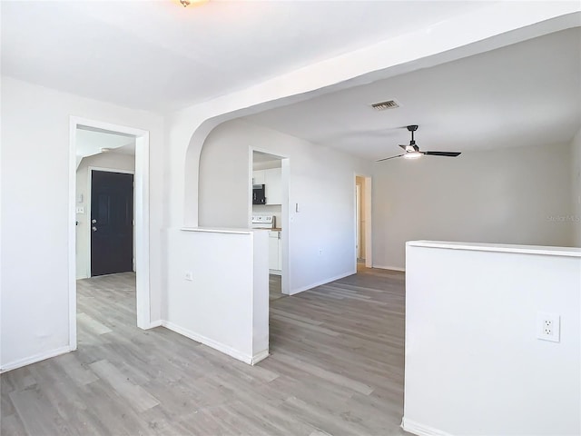 empty room featuring ceiling fan and light wood-type flooring