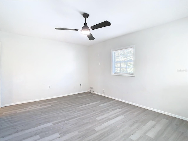 spare room with hardwood / wood-style flooring and ceiling fan