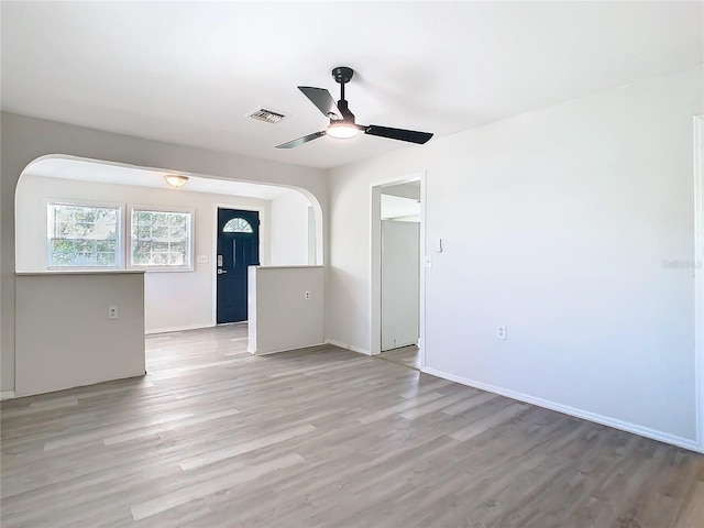 empty room featuring ceiling fan and light hardwood / wood-style flooring