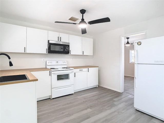 kitchen with sink, white cabinetry, ceiling fan, white appliances, and light hardwood / wood-style floors