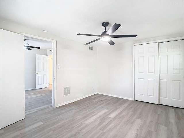 unfurnished bedroom featuring a closet, ceiling fan, and light hardwood / wood-style flooring