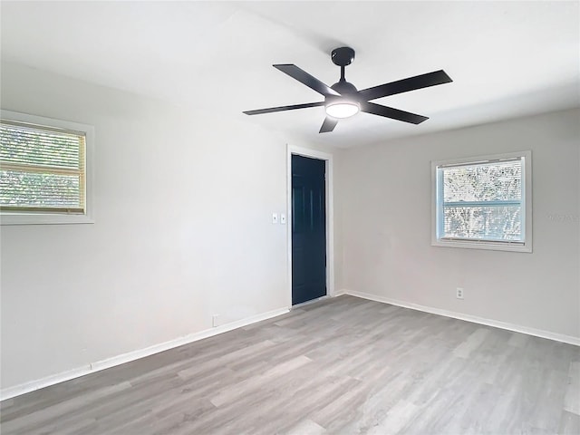 unfurnished room featuring ceiling fan and light wood-type flooring