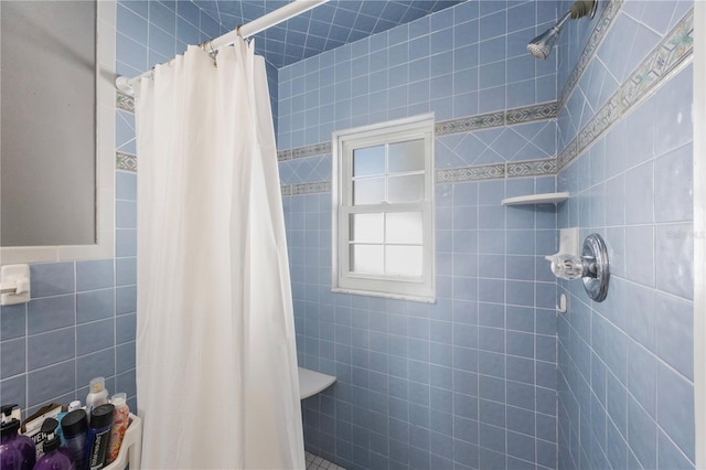 bathroom featuring tile walls and a shower with curtain