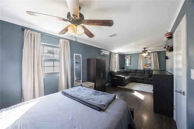 bedroom featuring dark hardwood / wood-style flooring, crown molding, a wall unit AC, and ceiling fan