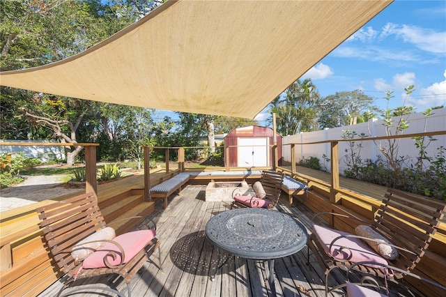 wooden deck featuring a storage shed