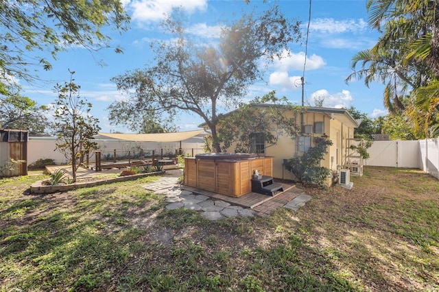 view of yard with a patio area and a hot tub