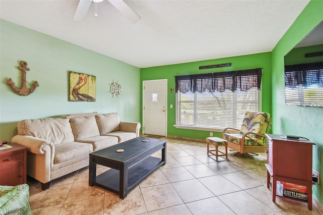 living room with light tile patterned floors, a textured ceiling, and ceiling fan