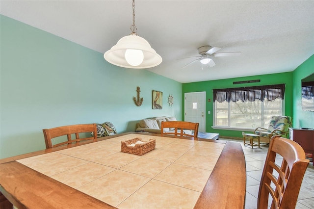 tiled dining room with ceiling fan