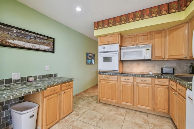 kitchen with white appliances, decorative backsplash, and light tile patterned flooring