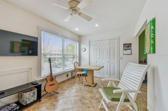 office with ceiling fan, a textured ceiling, and light tile patterned floors