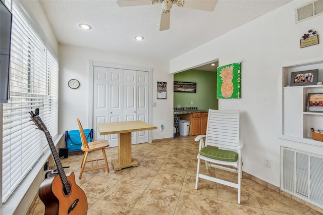 office with ceiling fan, a textured ceiling, and light tile patterned floors