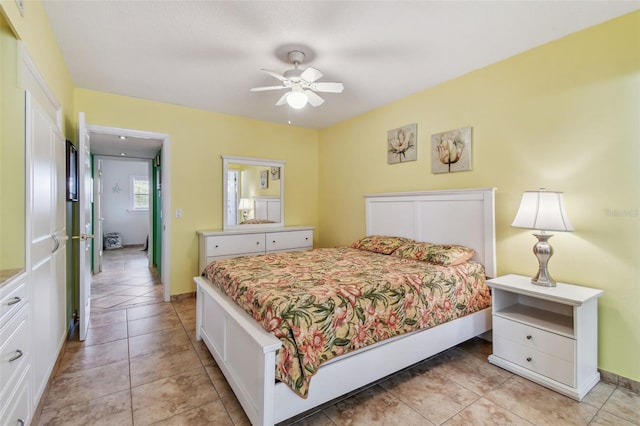 tiled bedroom featuring ceiling fan