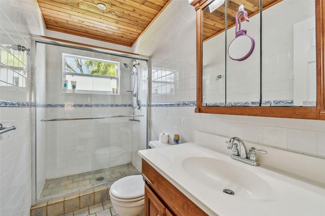 bathroom featuring toilet, a shower with shower door, wood ceiling, tile walls, and vanity