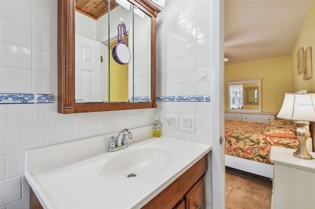 bathroom featuring vanity, tile patterned flooring, tasteful backsplash, and tile walls