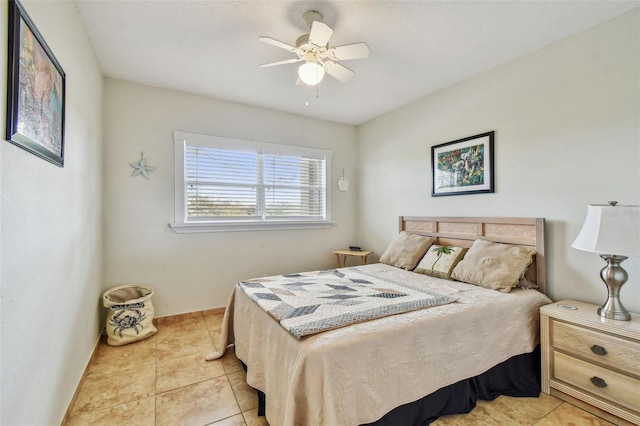 bedroom with ceiling fan and light tile patterned flooring