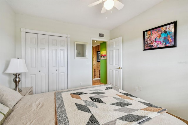 bedroom with ceiling fan and a closet