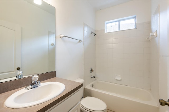 bathroom with shower / bath combination, toilet, and vanity