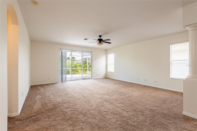 spare room with ceiling fan, baseboards, visible vents, and light carpet