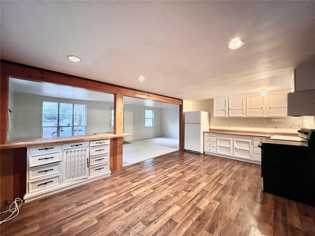 kitchen featuring white fridge, white cabinets, and light hardwood / wood-style flooring