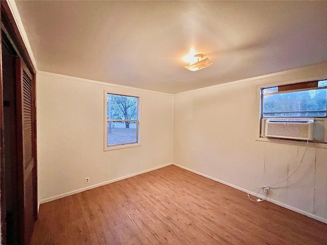 interior space with hardwood / wood-style flooring and cooling unit