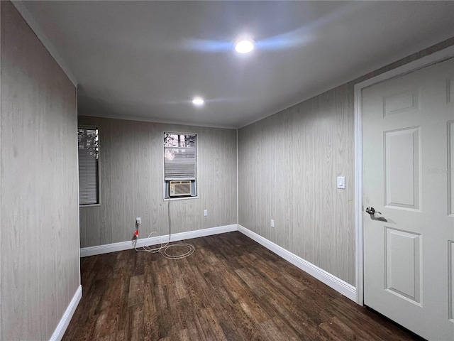 empty room with cooling unit and dark hardwood / wood-style flooring