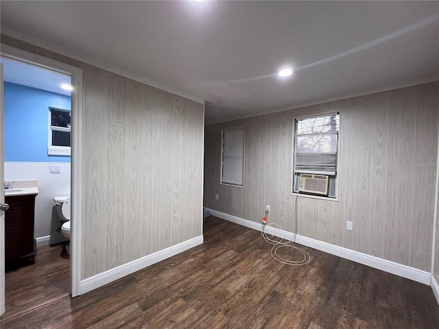 spare room with sink, dark wood-type flooring, and cooling unit