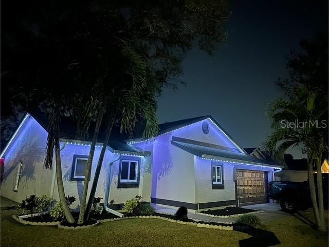 view of front of house with a garage and a yard