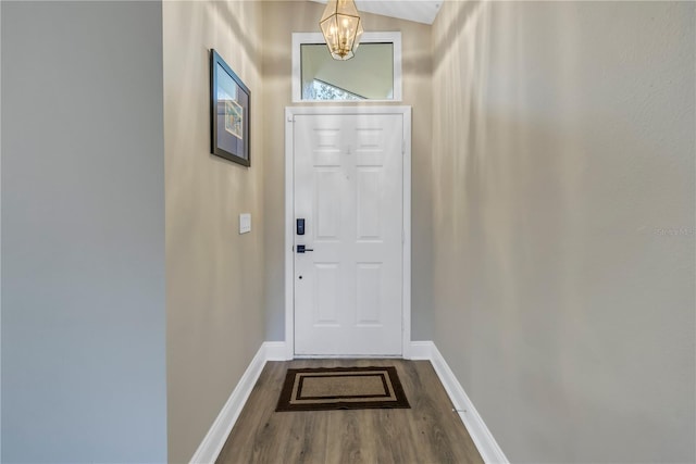 doorway with an inviting chandelier and wood-type flooring