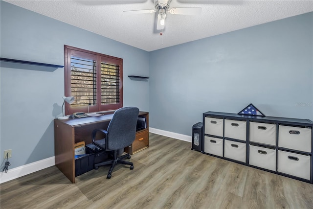 home office with ceiling fan, a textured ceiling, and light wood-type flooring