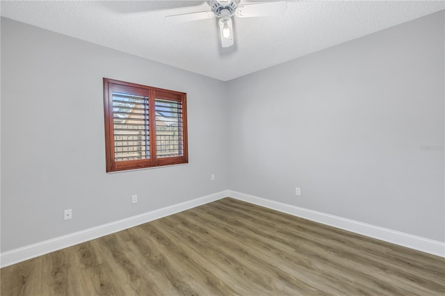 unfurnished room featuring ceiling fan, hardwood / wood-style flooring, and a textured ceiling