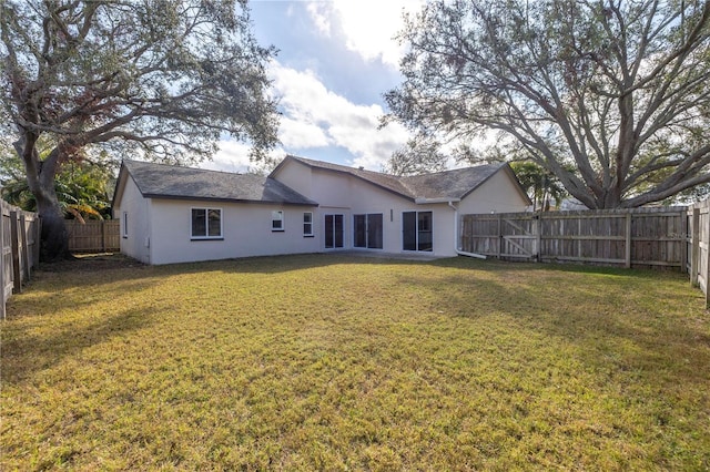 rear view of house with a yard