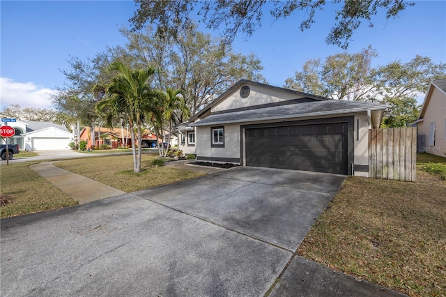 ranch-style home featuring a garage and a front yard