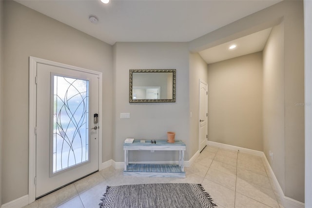 entrance foyer featuring recessed lighting, light tile patterned flooring, and baseboards