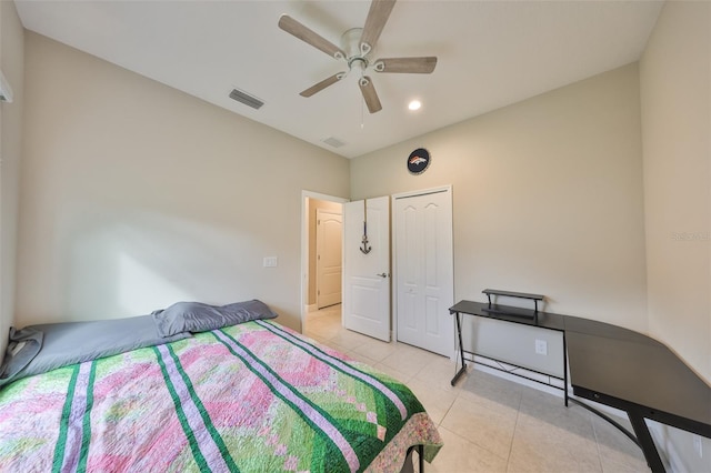 bedroom with light tile patterned floors, a ceiling fan, visible vents, and a closet