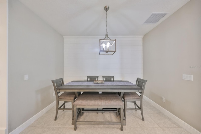 dining area with light tile patterned floors, baseboards, visible vents, and an inviting chandelier