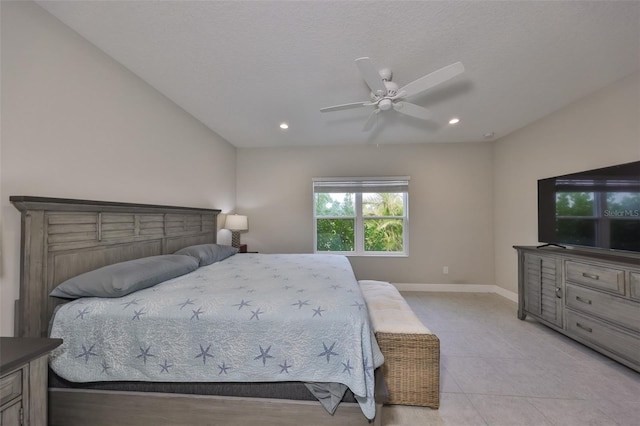 bedroom with ceiling fan, a textured ceiling, and light tile patterned floors