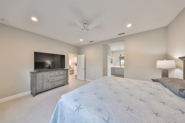 bedroom featuring ceiling fan, light tile patterned floors, and ensuite bath