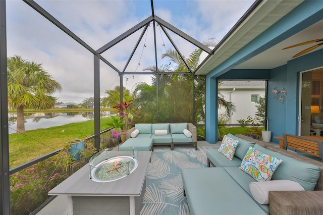 sunroom with a water view and ceiling fan