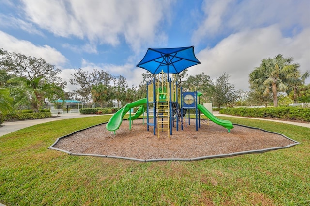 view of jungle gym featuring a lawn