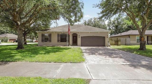 ranch-style house with a garage and a front yard