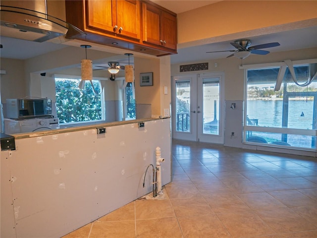 kitchen with french doors, ceiling fan, and light tile patterned flooring