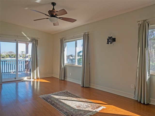 unfurnished room with hardwood / wood-style floors and ceiling fan