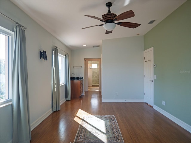 interior space featuring dark wood-type flooring and ceiling fan