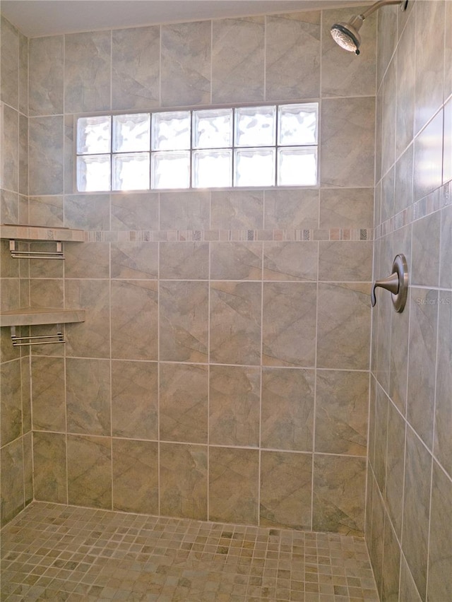 bathroom with a tile shower