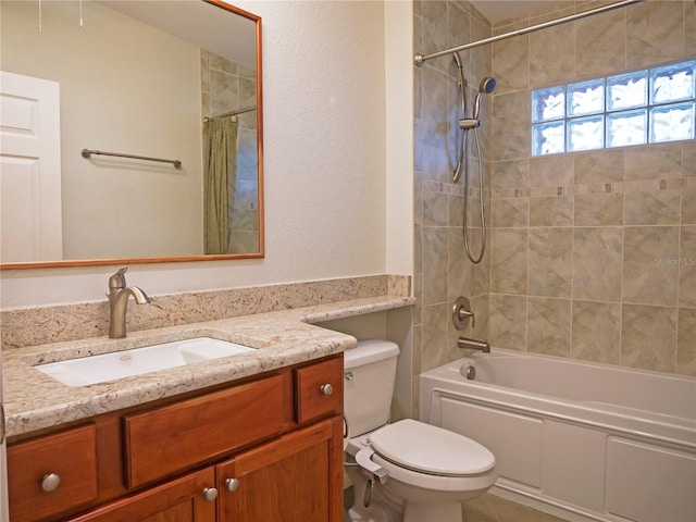 full bathroom with vanity, tiled shower / bath combo, and toilet