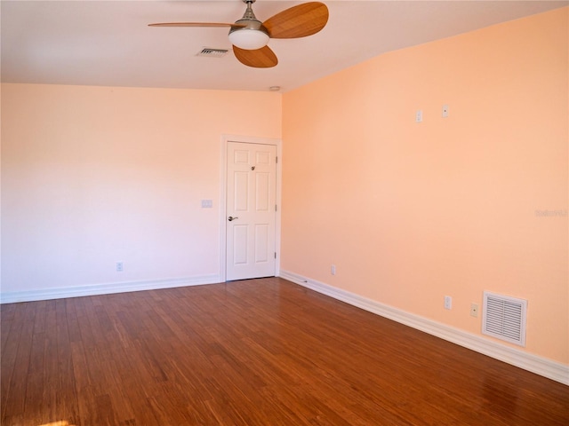 empty room featuring hardwood / wood-style floors, vaulted ceiling, and ceiling fan