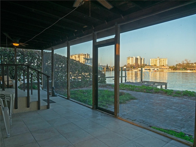 unfurnished sunroom featuring a water view