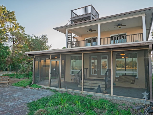 rear view of property with a patio, a balcony, ceiling fan, and a sunroom